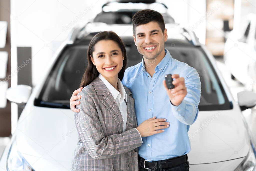 Family Showing Car Key Embracing In Dealership