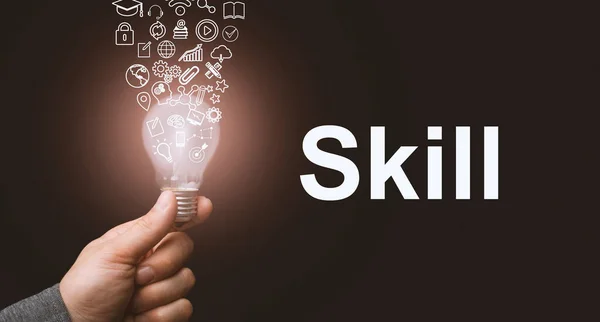 Skill concept. Abstract luminous light bulb in hands, knowledge, qualification and experience symbols fly out from it — Stock Photo, Image