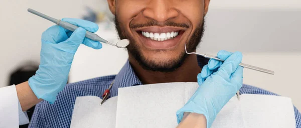 Cortado de mãos de dentista com ferramentas e paciente homem sorridente — Fotografia de Stock