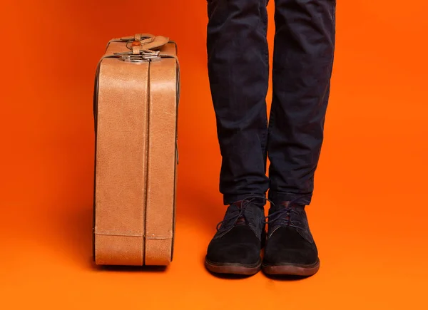 Oříznuté mužské nohy vedle stylového kufříku — Stock fotografie