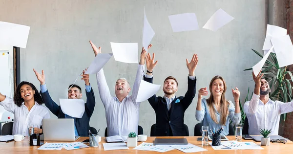 Joyful Business People Throwing Papers Sitting In Modern Office, Panorama