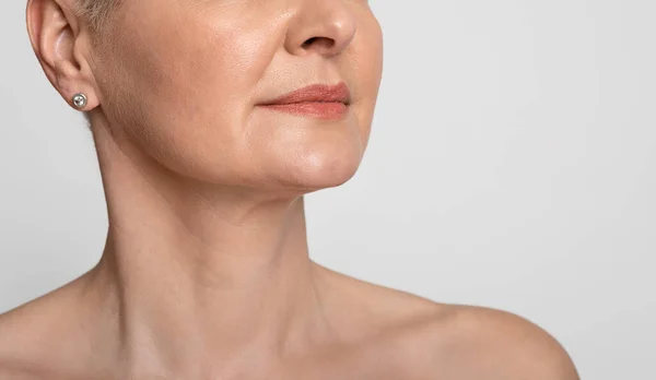 Skin Lifting. Mature woman with smooth skin over light background, cropped image — Stock Photo, Image