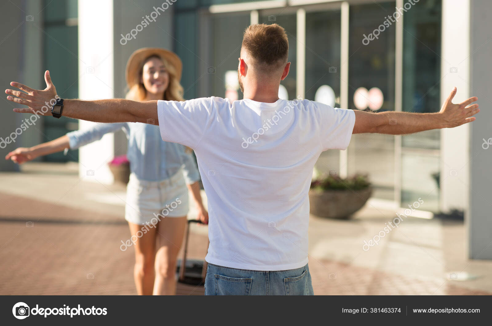 Boyfriend picking up his girlfriend near airport building Stock Photo
