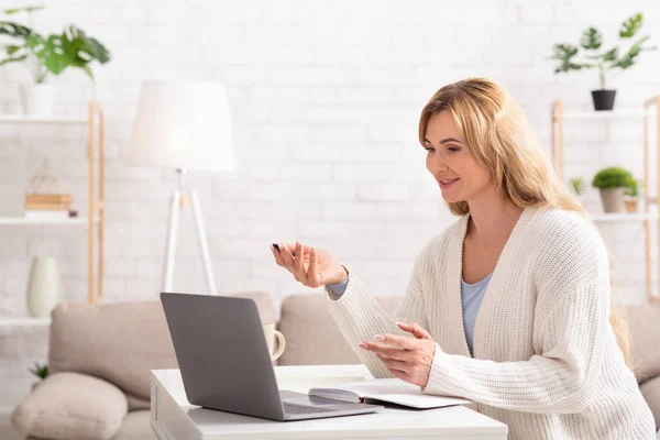 Online business meeting. Woman communicates with client in laptop