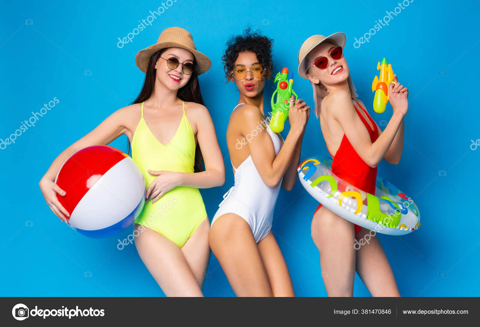 Young Girls In Swimsuits Having Fun With Swim Toys Over Blue Background  Stock Photo by ©Milkos 381470846