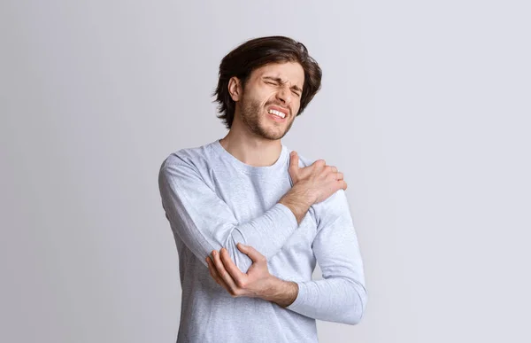 Medical problems concept. Man suffers from elbow pain — Stock Photo, Image