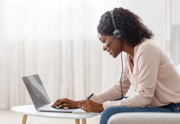 Concepto de Educación en Línea. Mujer africana joven estudiando en el ordenador portátil en casa — Foto de Stock