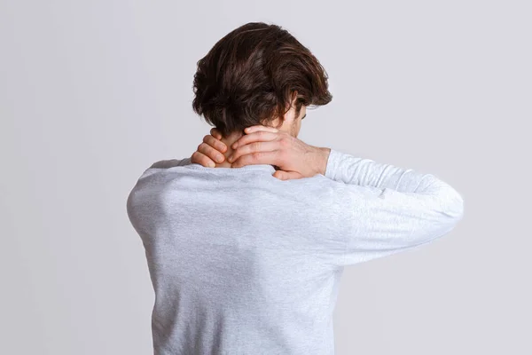 Muscle pain. Man makes massage to himself on neck — Stock Photo, Image