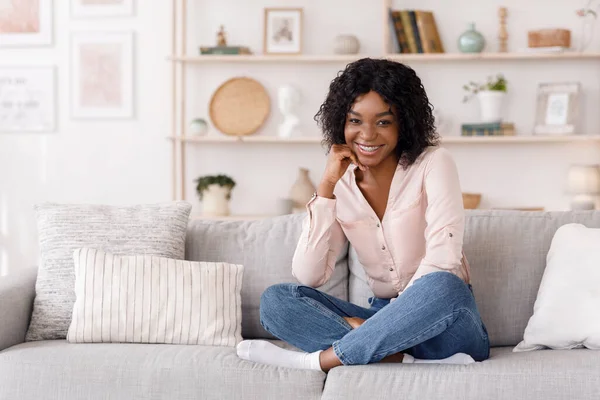 Happy African Girl Posing In Stylish Living Room Interior, Smiling At Camera