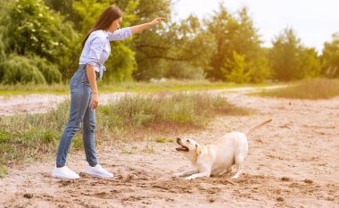 İtaatkar köpeğine emir veren bir kadın.