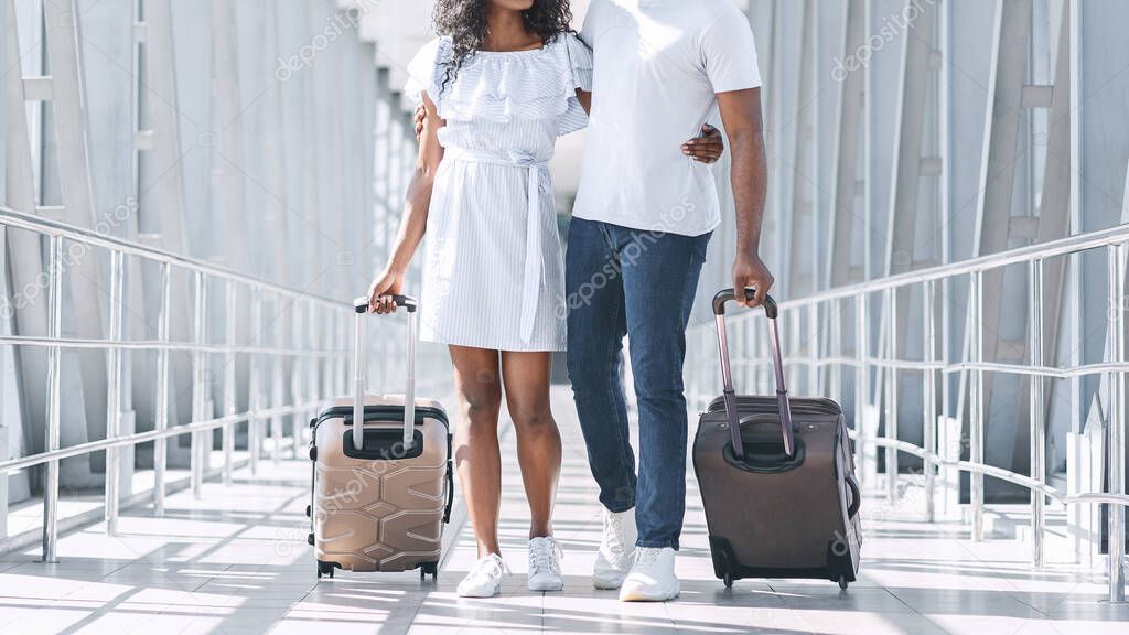 Unrecognizable Afro Couple Walking In Airport Corridor With Suitcases, Ready For Flight