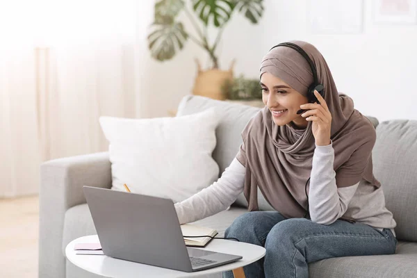 Formación en línea. Chica musulmana feliz viendo webinar educativo en el ordenador portátil en casa — Foto de Stock