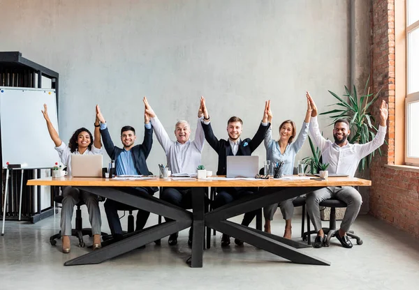 Colleagues Giving High-Five Celebrating Business Success Standing In Office  Stock Photo by ©Milkos 381522740