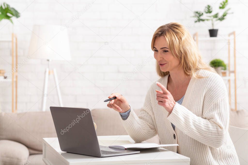 Teacher online. Gesturing by hands woman teaching student on laptop