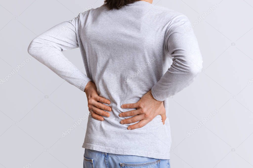 Renal colic and back pain. Man suffers from lower back pain