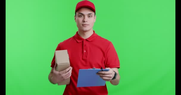 Friendly courier with parcel giving notepad to camera a — Stock Video