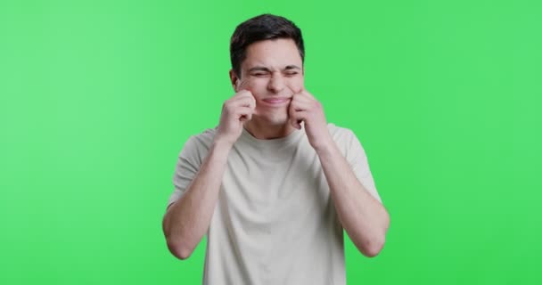 Rolig kille som håller händerna på kinderna och ler — Stockvideo