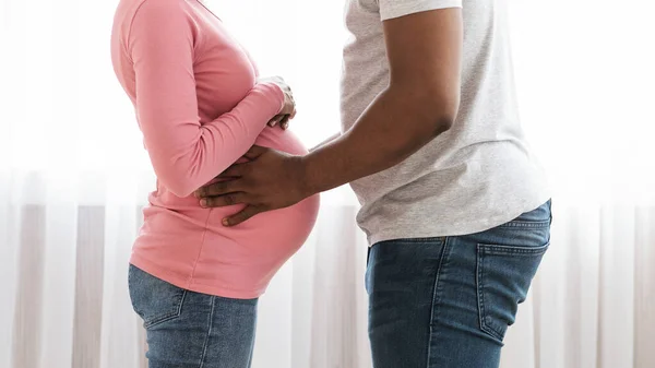 Обрезанный муж трогает свою беременную жену за живот — стоковое фото
