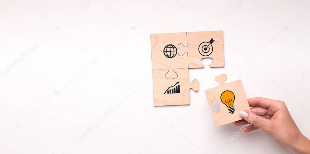 Business Strategy. Woman putting piece of puzzle with lightbulb as idea symbol