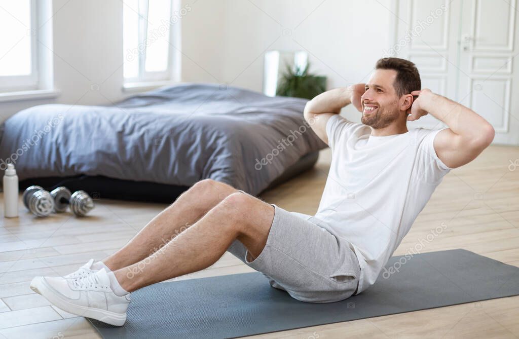 Man Exercising Doing Abs Sitting On Mat Training At Home