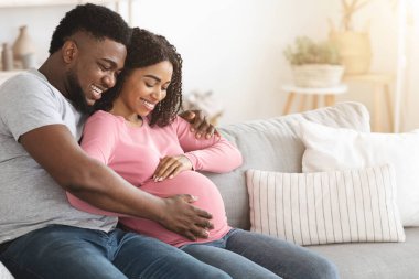 Happy black married couple waiting for baby clipart