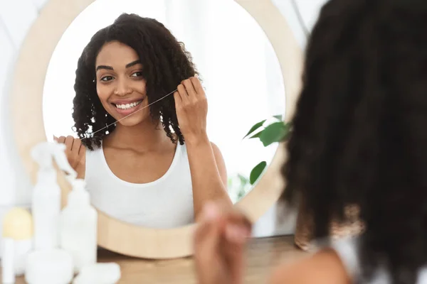 Oral Hygiene. Beautiful african american girl using dental floss at home — Stock Photo, Image