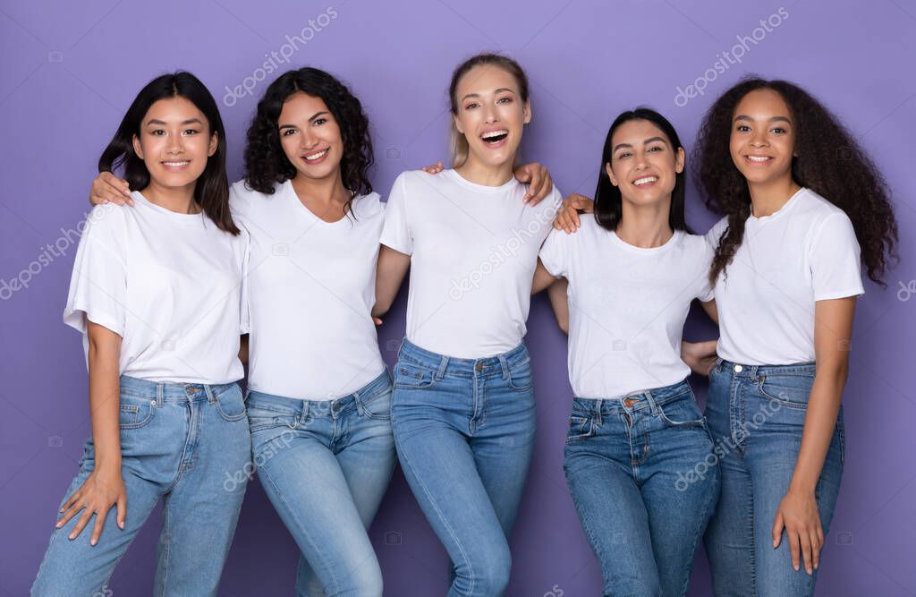Diverse Women Embracing Standing Over Purple Background, Studio Shot