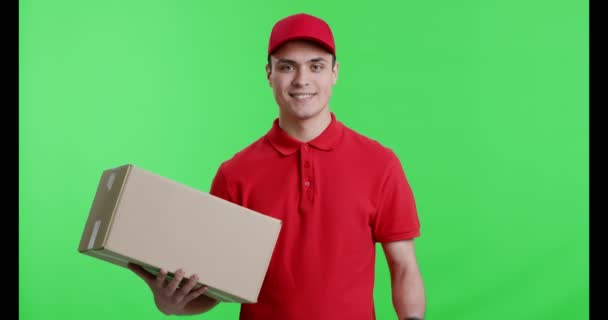 Friendly delivery guy with package gesturing thumb up — Stock Video