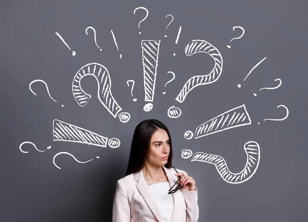 Ideeën voor zaken. Vraagtekens, uitroeptekens rond dure zakenvrouw — Stockfoto