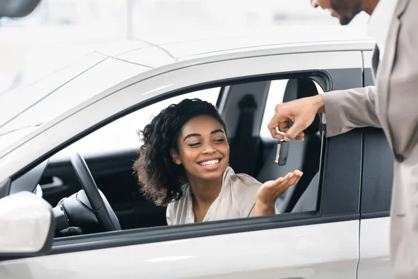 Seller Giving Lady Key For Test Drive In Dealership Showroom — Stock Photo, Image