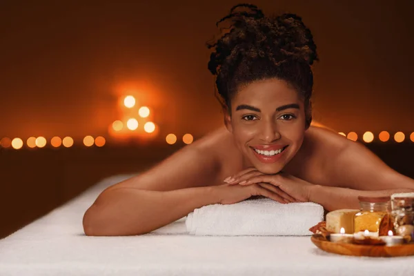 Portrait of beautiful woman lying on massage table at spa — Stock Photo, Image