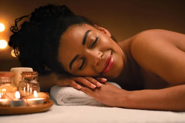 Closeup of joyful black lady sleeping at spa salon — Stock Photo, Image