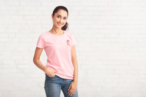 Volunteer In T-Shirt With Ribbon Symbol Standing Over White Wall — Stock Photo, Image