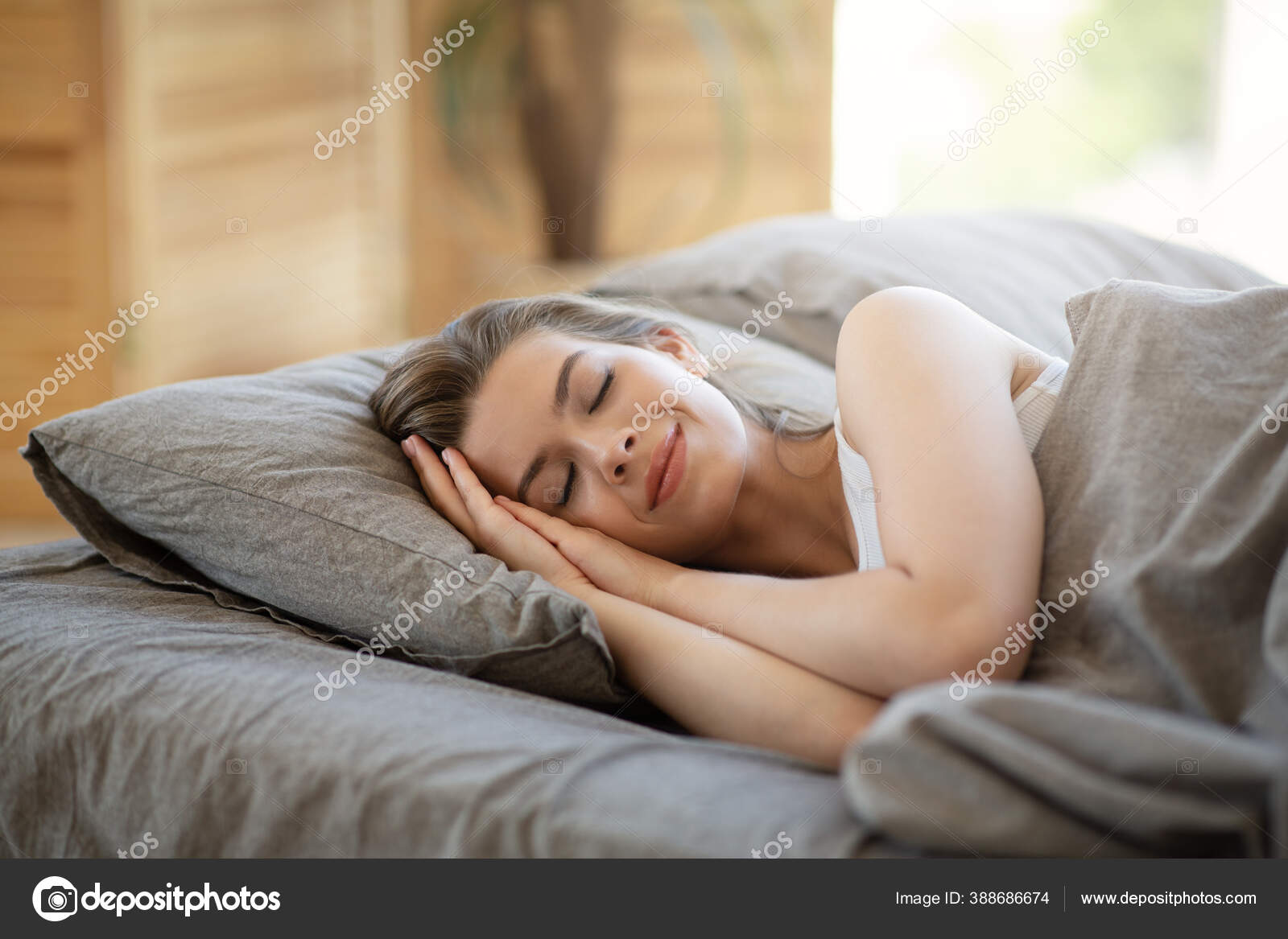 Beautiful young woman sleeping in her comfy bed covered with blanket at  home Stock Photo by ©Milkos 388686674