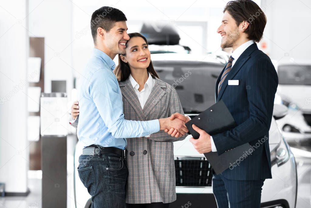 Handsome Manager Shaking Hands With Young Buyers