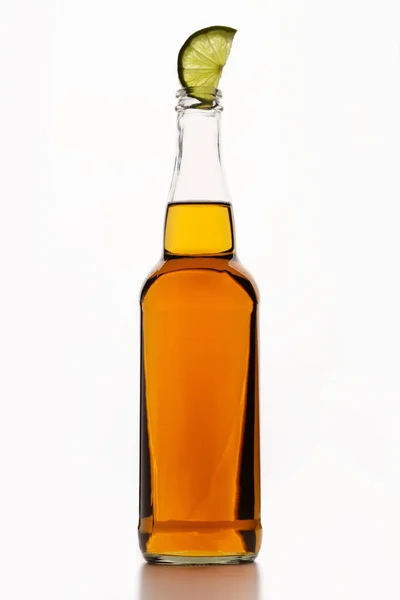 Beer to serve client. Light ale in bottle with lime on white background — Stock Photo, Image