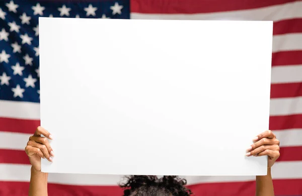 Blank poster for text in hands over US flag, empty space