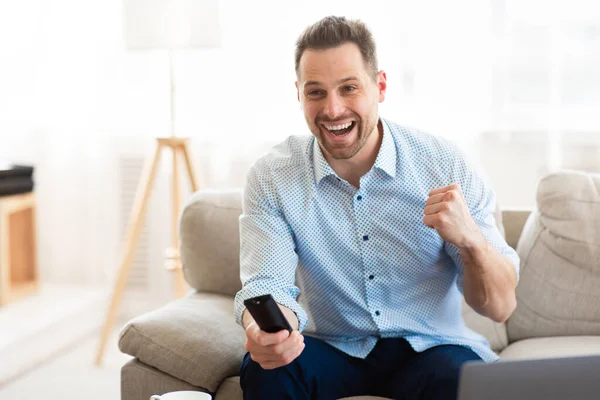 Emotional man watching football game at home — Stock Photo, Image