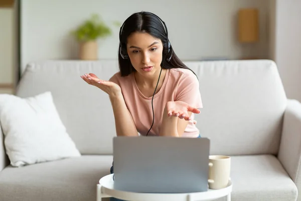 Kobieta na laptopie Dokonywanie połączeń wideo Noszenie słuchawek w domu — Zdjęcie stockowe