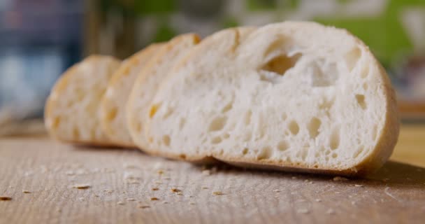 Pão cortado recém-assado na mesa de cozinha rústica, close-up — Vídeo de Stock