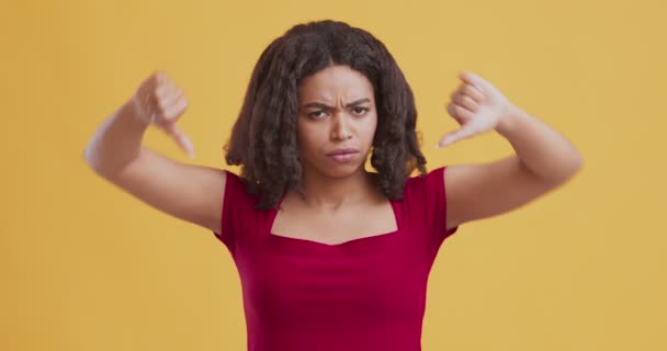 Mrzutá africká americká žena ukazující palce dolů — Stock video