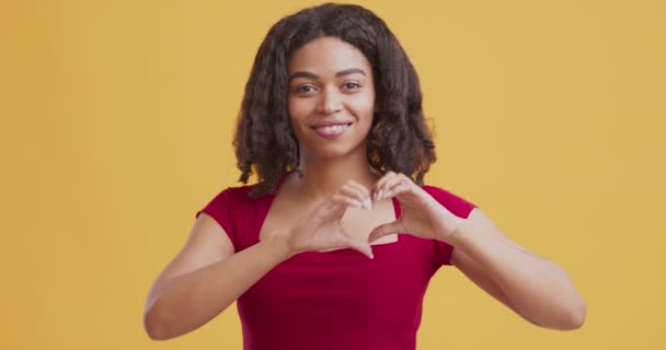 Romántico afroamericano chica haciendo signo de corazón con los dedos — Vídeos de Stock