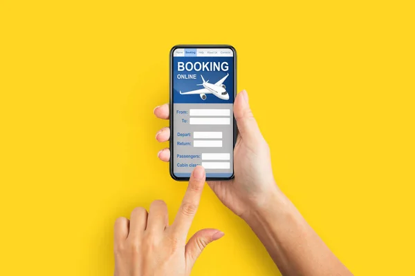 Woman Booking Flight Online Holding Phone Over Yellow Background, Closeup — Stock Photo, Image