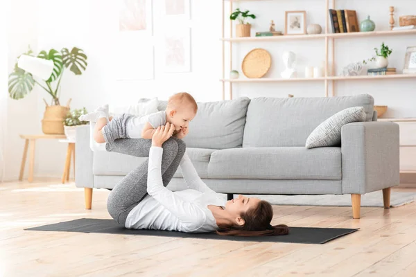 Sport With Baby. Fit Mom Exercising With Her Toddler Son At Home