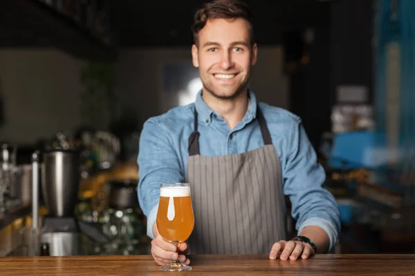 Cerveza y cerveza artesanal en pub. El hombre sirve un vaso de cerveza ligera — Foto de Stock