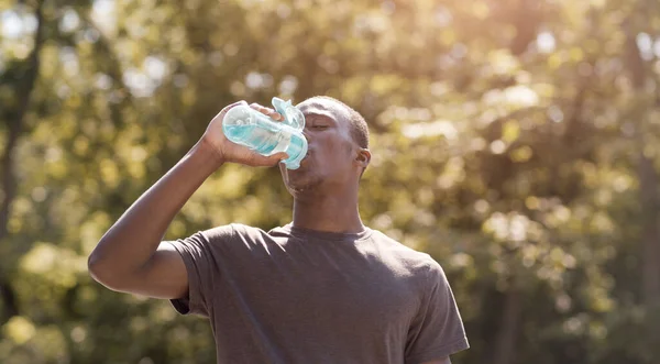 Black man drinking water, suffering from hot weather