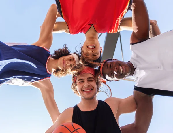 Smiling basketballers put their head together in unity outside, bottom view — Stok Foto