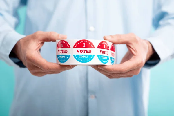 Man holding I voted today stickers roll — Stock Photo, Image