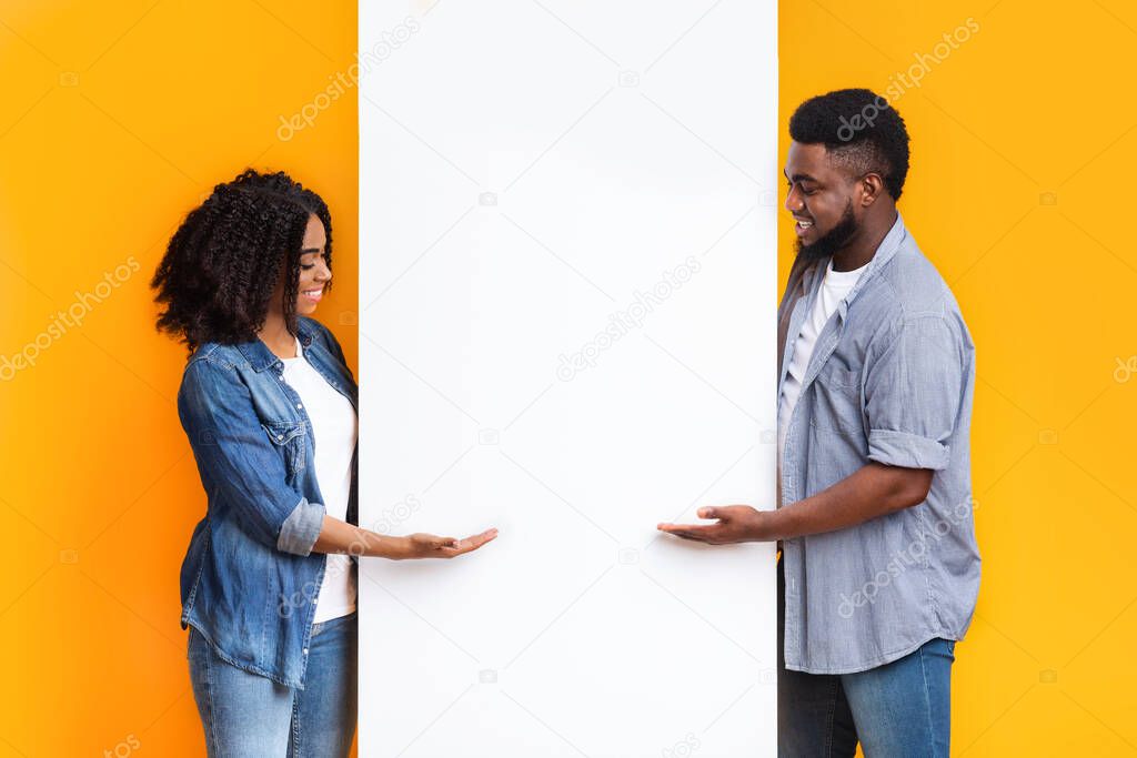 Great Offer. Cheerful African Couple Showing Free Space On Blank Advertising Board