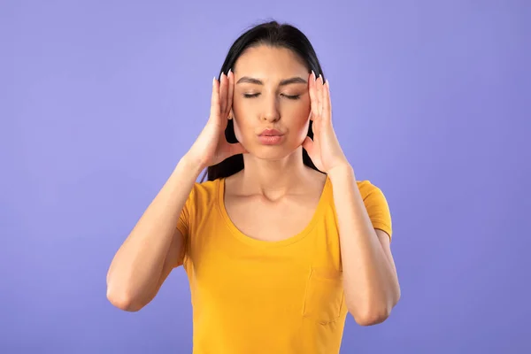 Woman practicing breathing yoga exercise at the studio